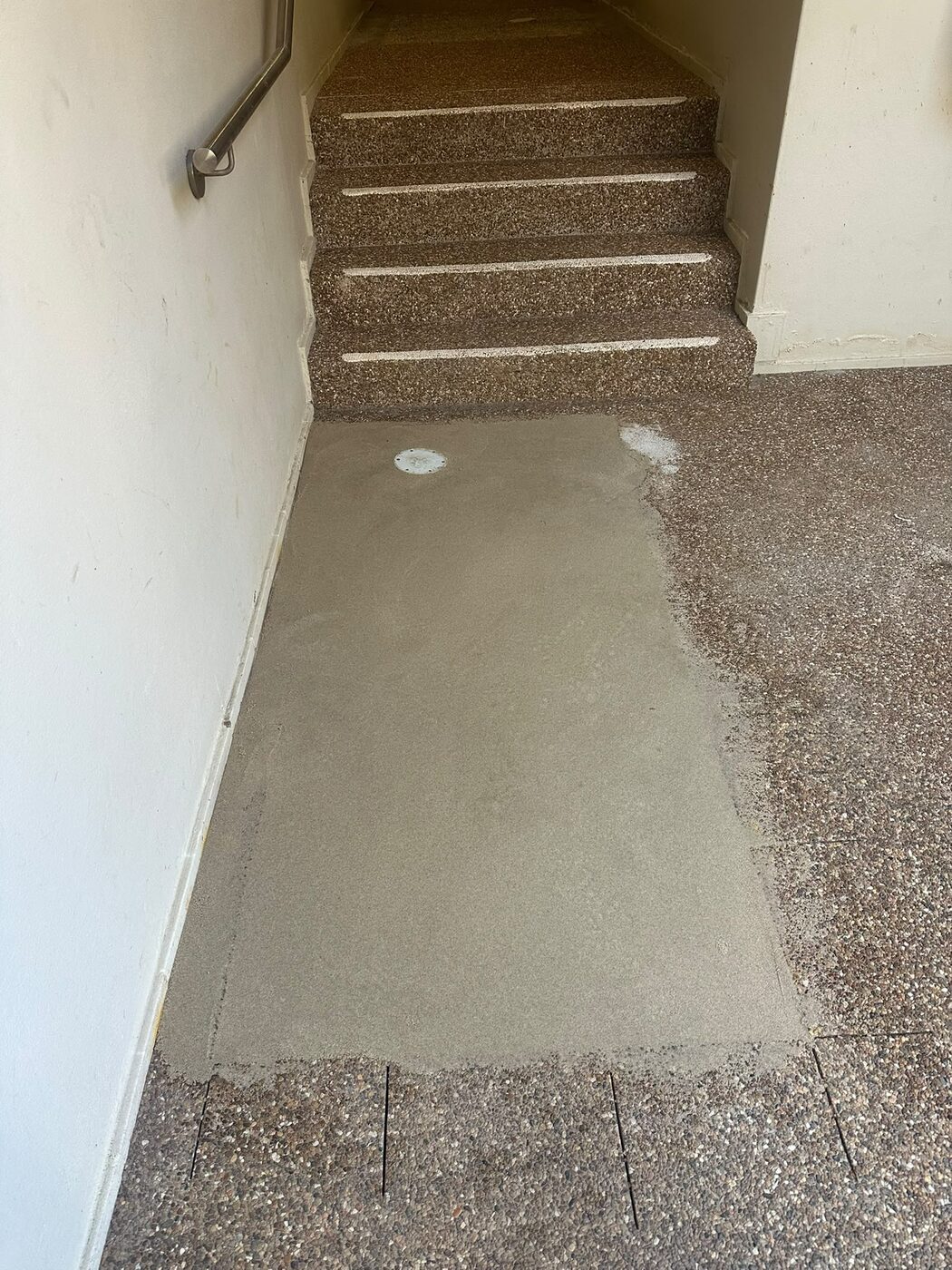 Damaged pebblecrete corridor at a Marsfield retirement village before repair