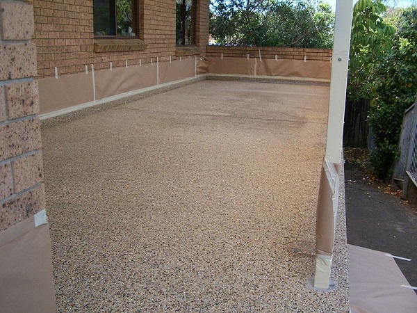 a concrete patio with a white pole