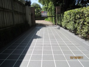 After - a grey tile driveway with white grout
