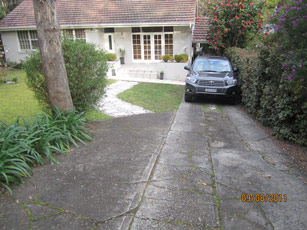 A damaged driveway with a car