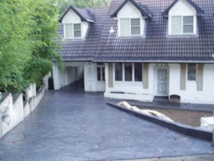 a house with a new concrete driveway