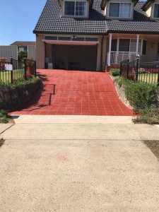 a red brick driveway with a garage door
