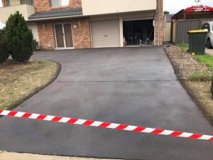 a driveway with red and white tape