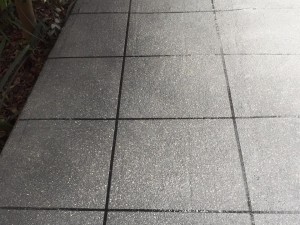 a grey tile floor with black grout