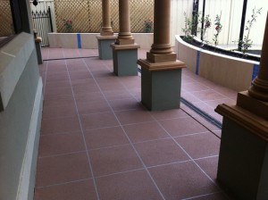 a group of pillars on a tiled floor