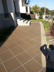 a brown tile walkway with white lines