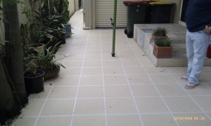 a white tile floor with a pole