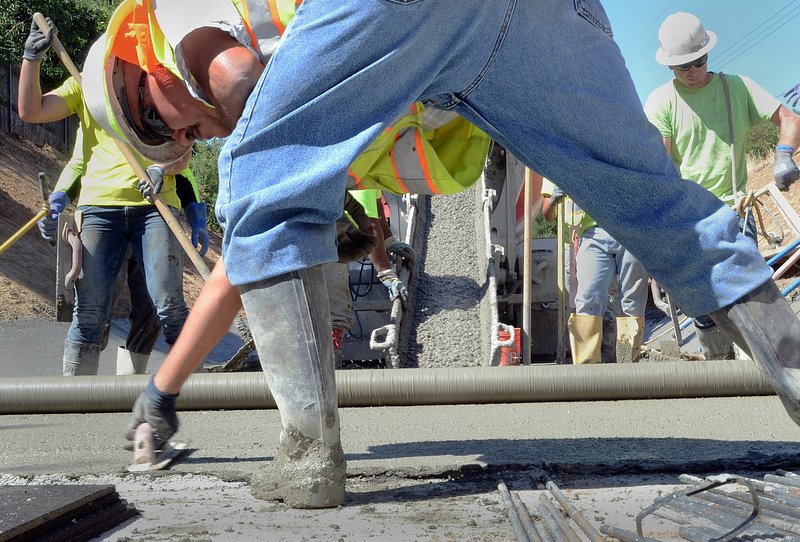a construction worker in a yellow vest and jeans